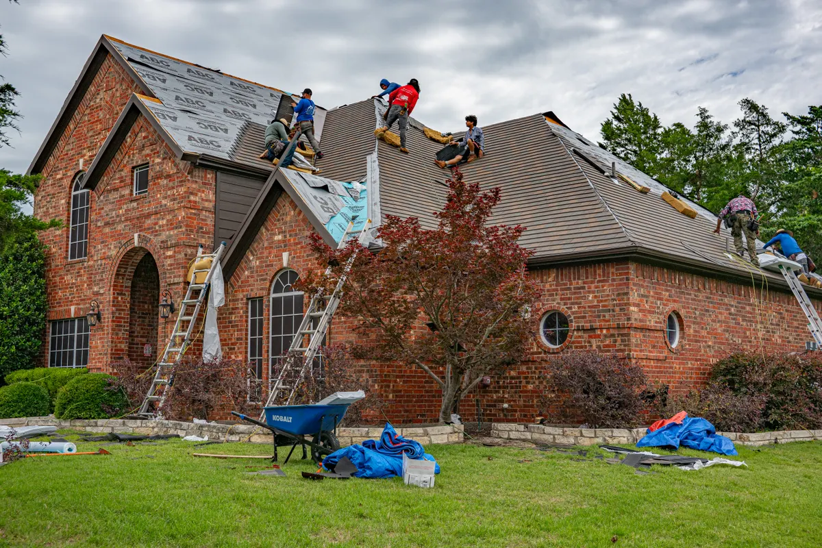 A roofing crew working on a brick home in Texas
